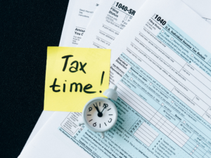 Tax Time sticky note on 1040 tax forms